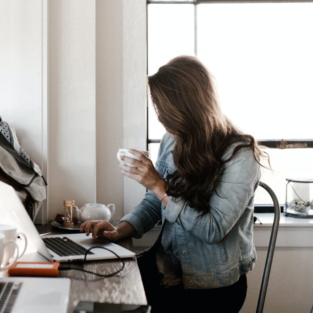 Woman sitting in office with coffee